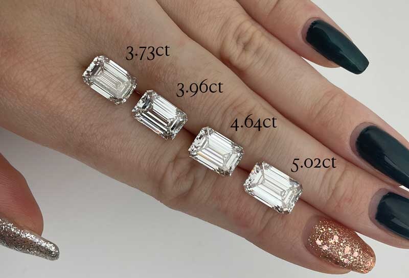 Emerald Cut Diamonds Ranging in Carat Size on Hand